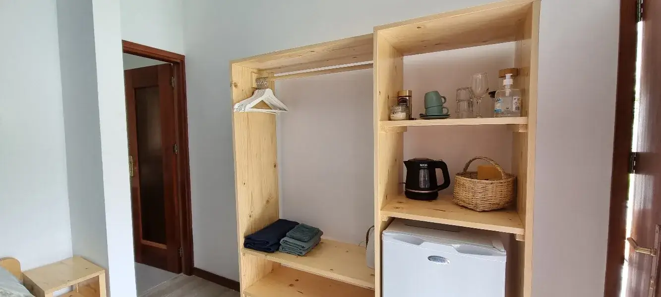 Open wardrobe, minibar and coffee corner in the Blue Room