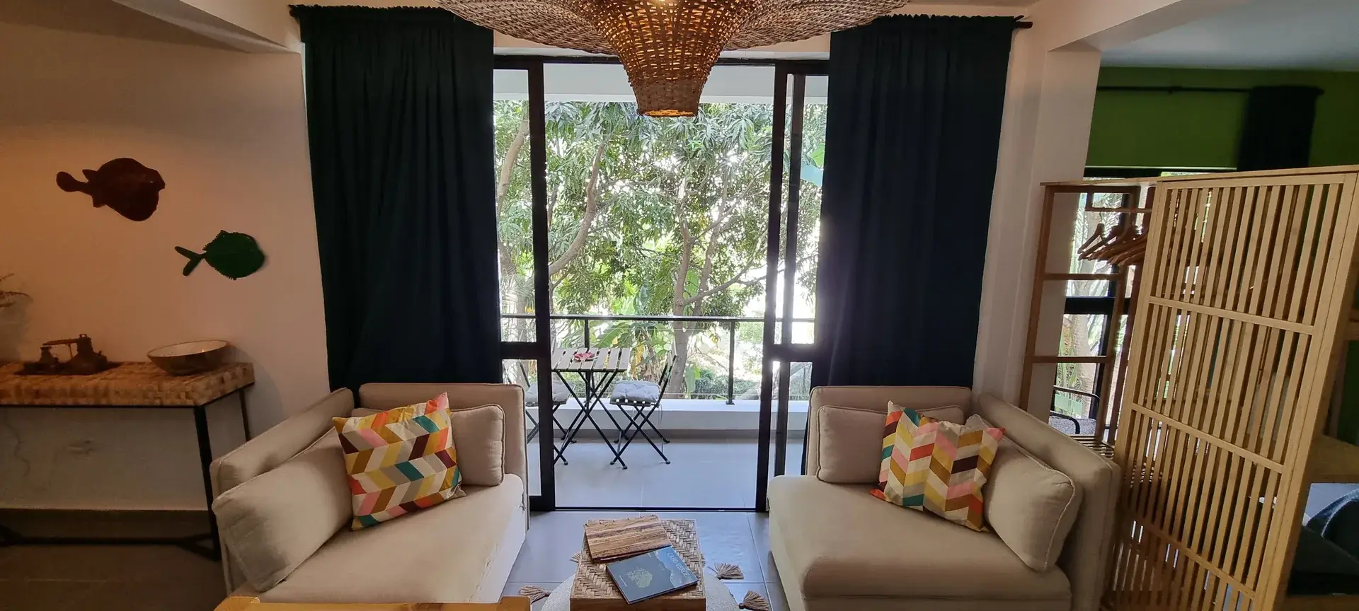 Bright Green Room living area with two armchairs and access to the balcony