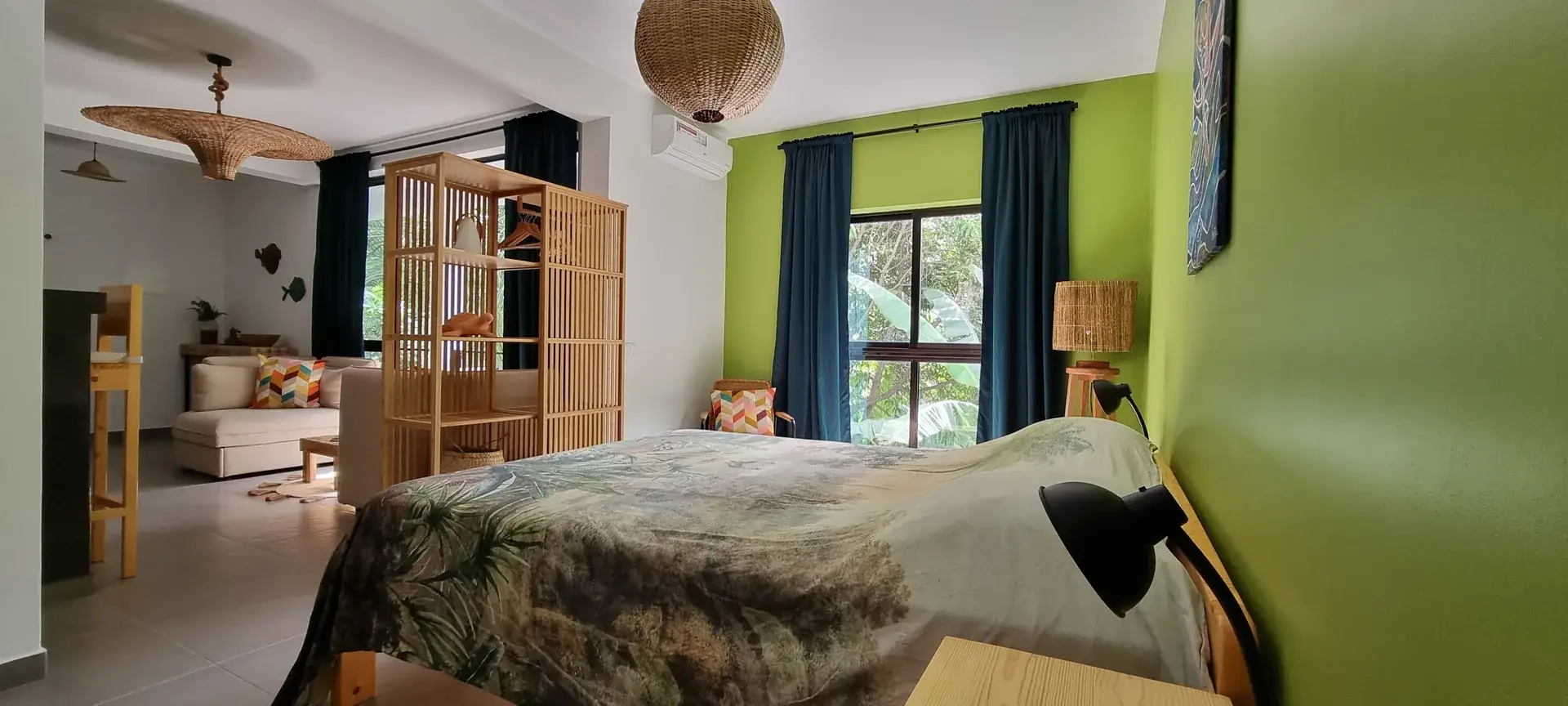 Double bed and living area in the spacious Green Room studio