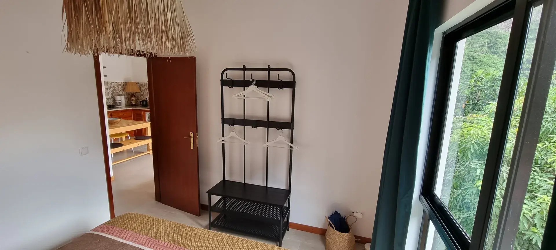 Orange Room bedroom with open wardrobe and garden views