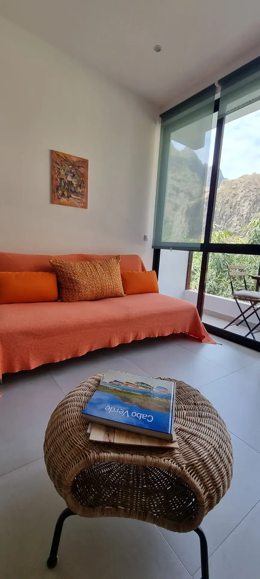 Orange Room living area with a sofa and mountain views through large windows
